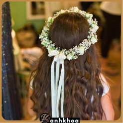 Beautiful woman wearing a fresh flower wreath on her head