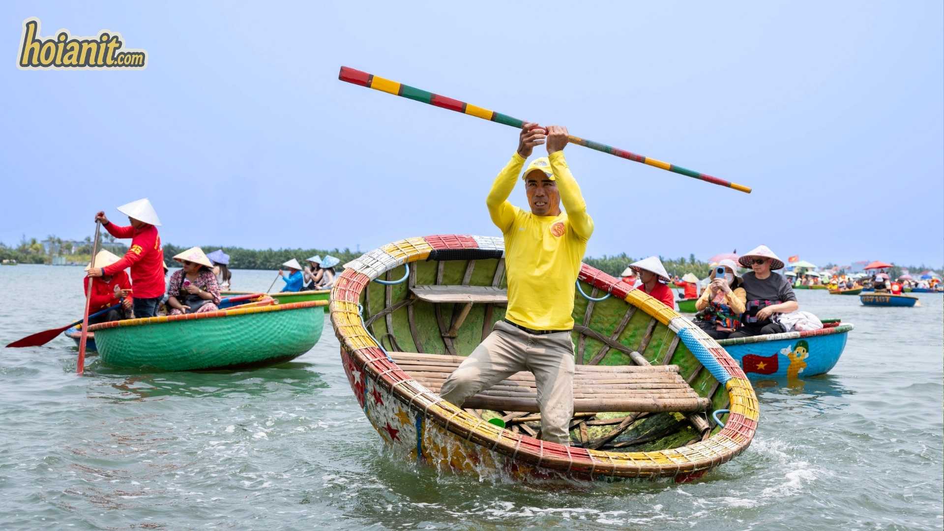 Boatman spinning a round basket boat on a Hoi An basket boat trip in Cam Thanh