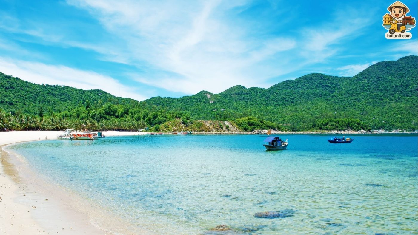 Cham Island Tourists relaxing on the beach at Cham Islands with turquoise sea and fishing boats – a peaceful retreat in the Hoi An Budget Guide under $100.