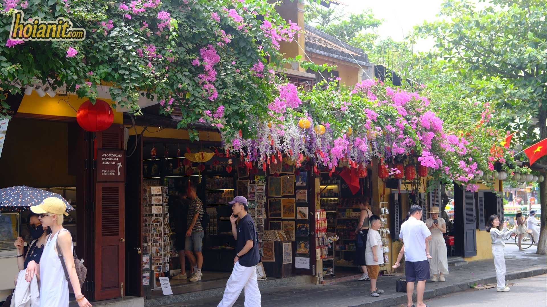 Bougainvillea over shopfronts in Hoi An Ancient Town, a slow travel morning walk