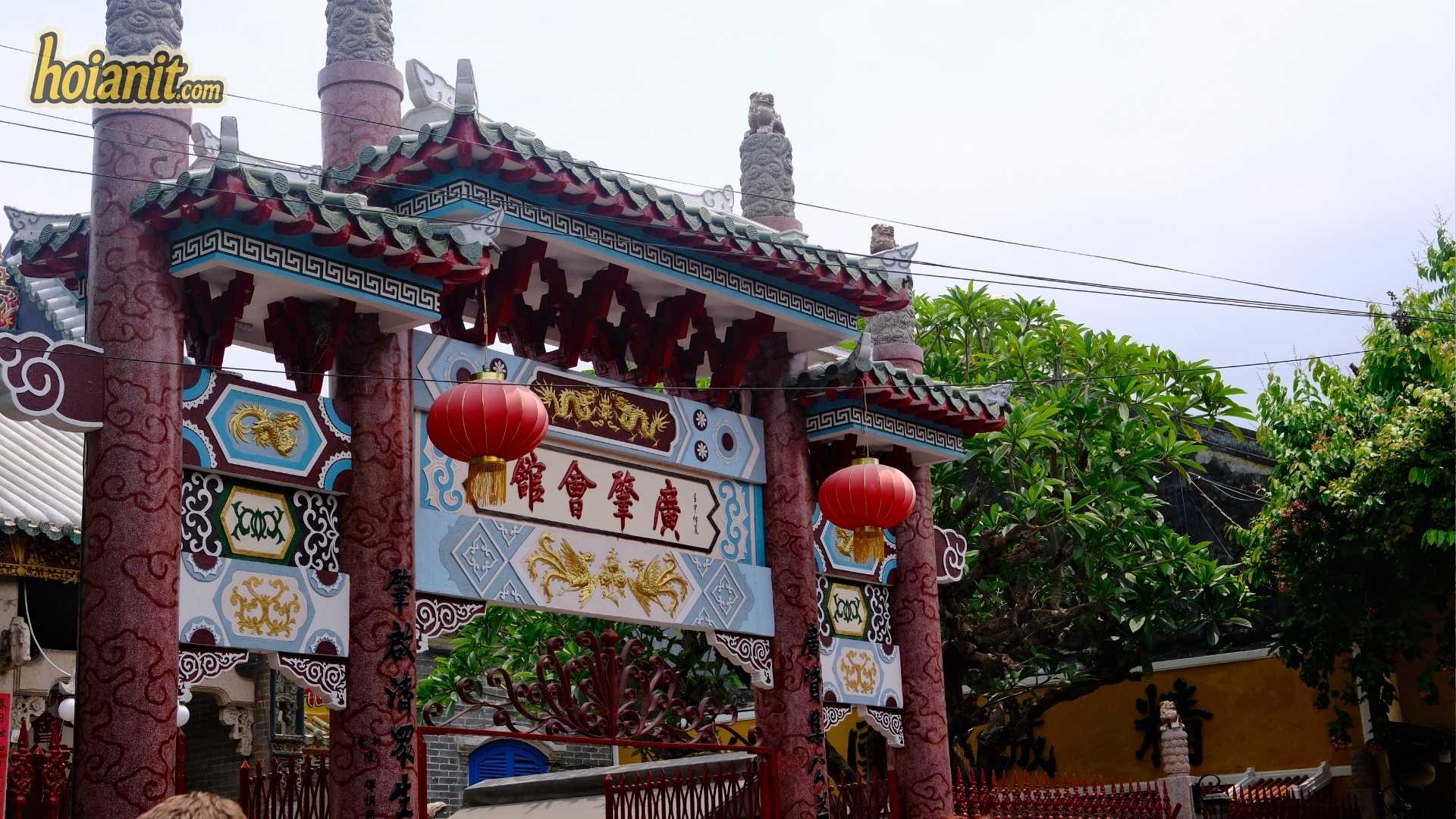 Ornate assembly hall gate with red lanterns in Hoi An Ancient Town