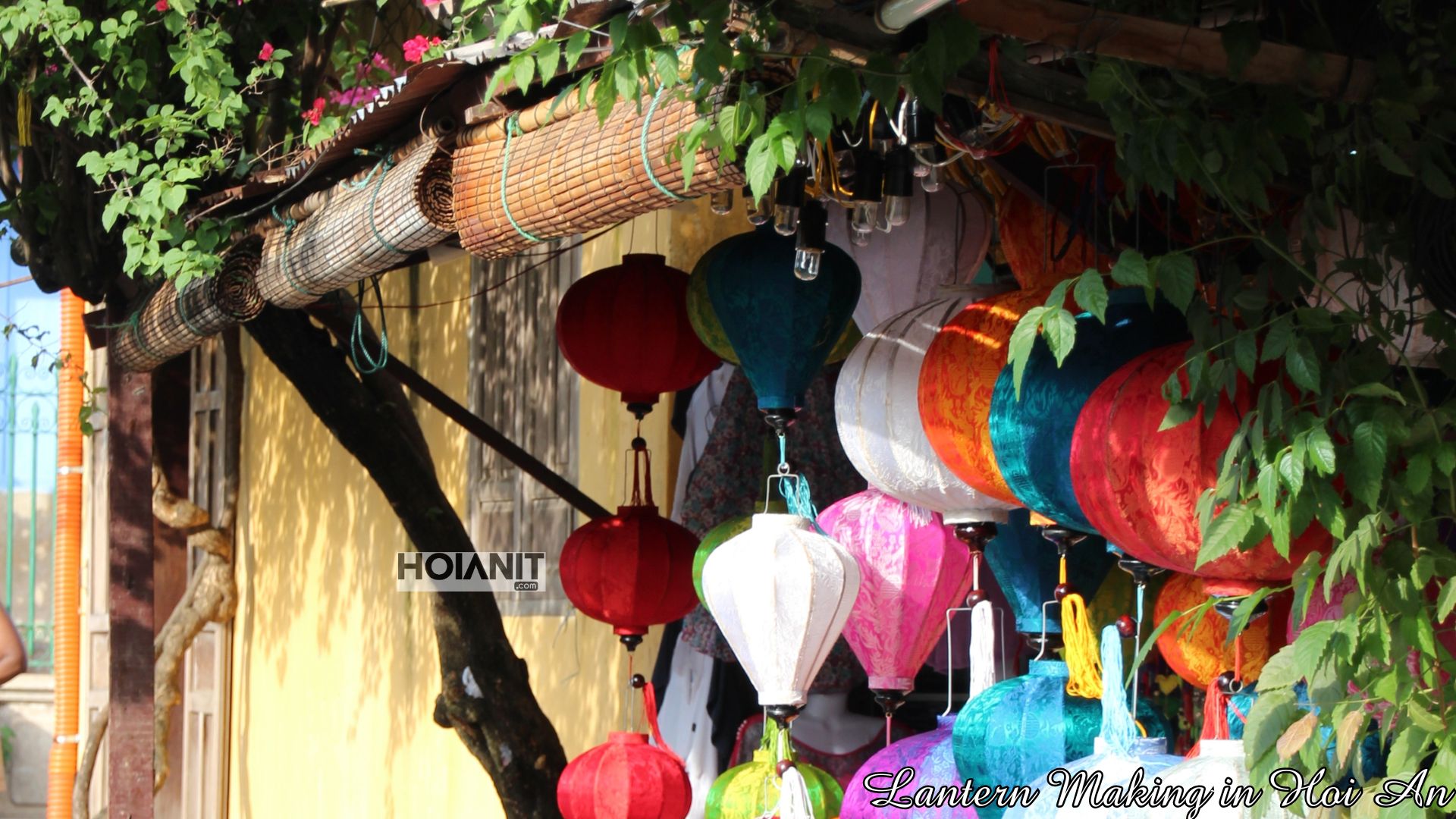 Lanterns hanging under a tiled roof in a Hoi An lane