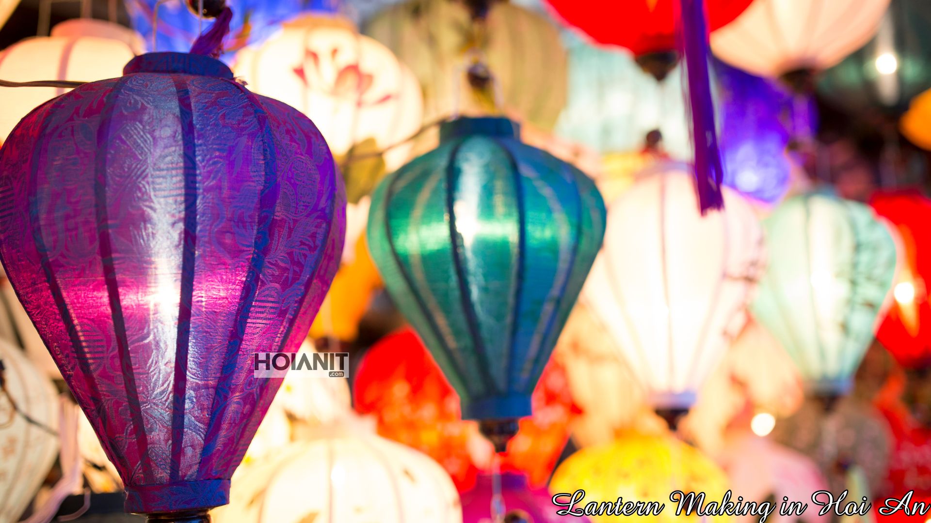 Close-up of purple and blue silk lanterns lit from inside