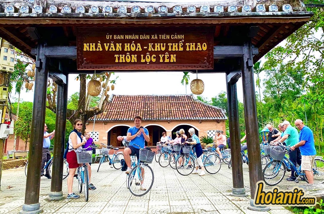 Loc Yen 3 Visitors with bicycles at the gate of the Loc Yen village cultural house, Tien Phuoc