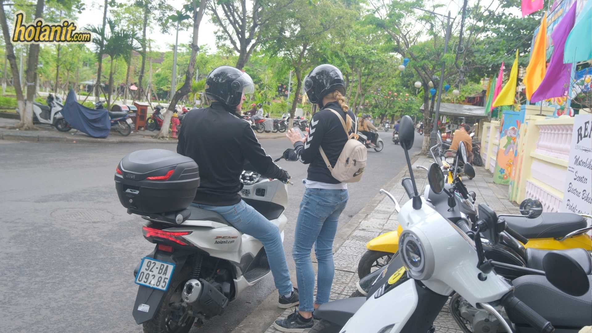 Need a License to Ride a Motorbike in Hoi An 3 Couple checking their route before riding a rental motorbike in Hoi An