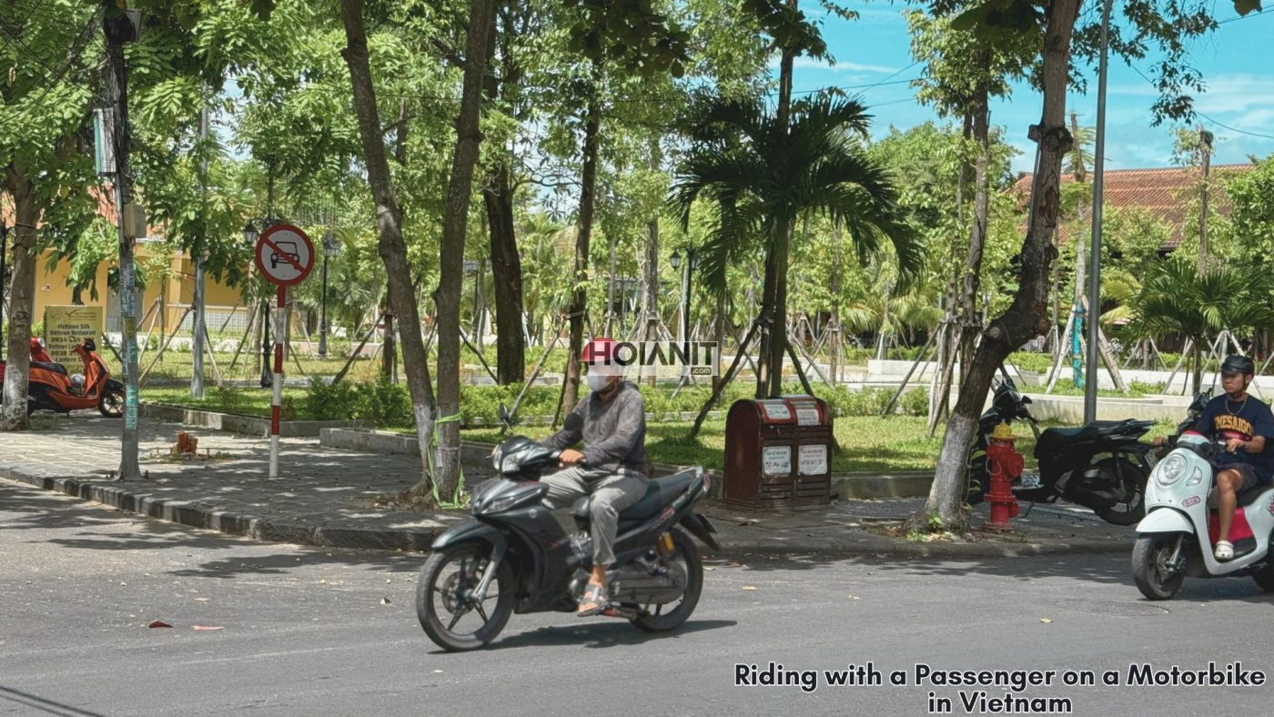 two people on a scooter crossing rice fields near Hoi An