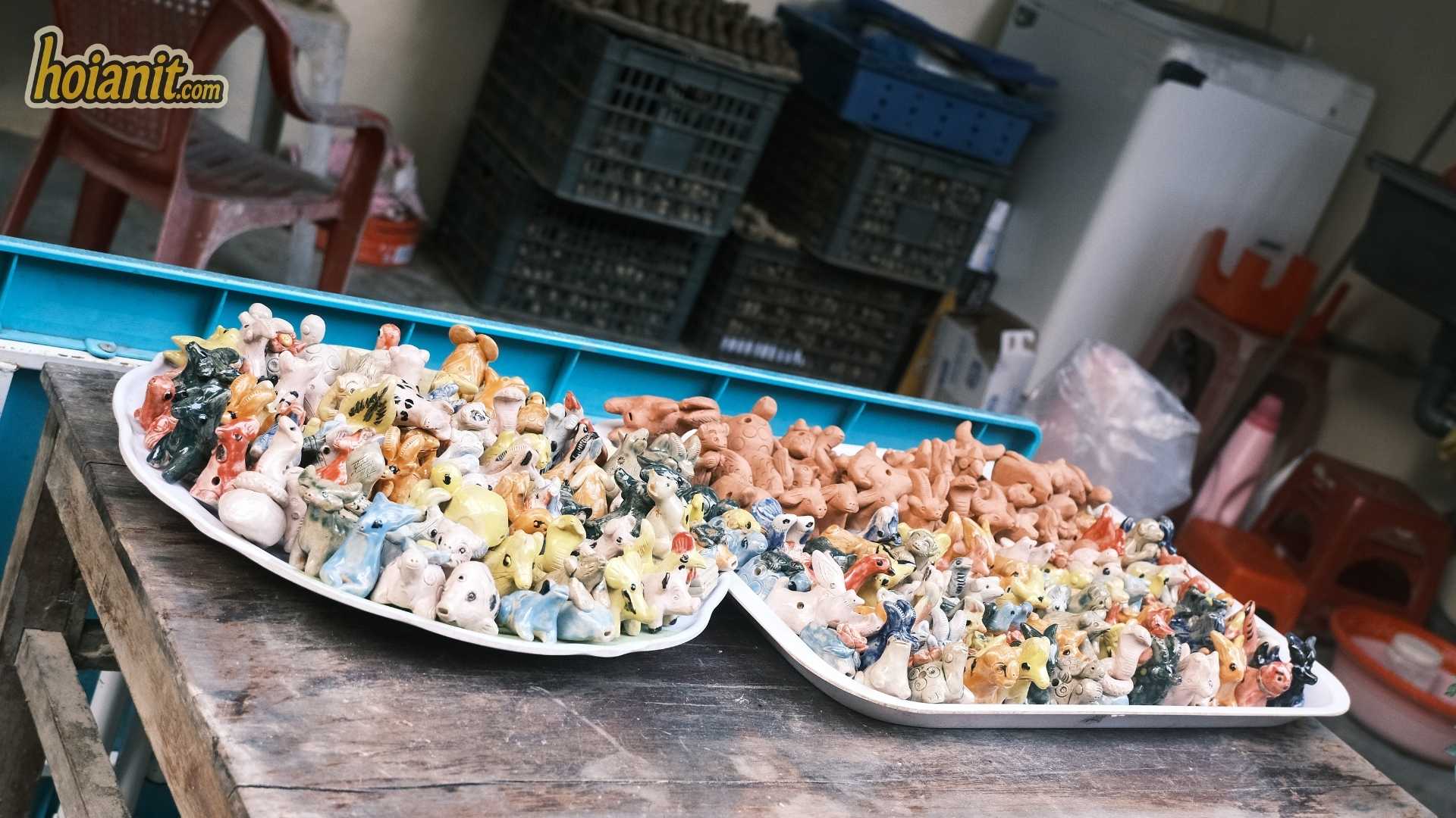 Tray of painted clay whistle figurines sold as Hoi An souvenirs at Thanh Ha pottery village