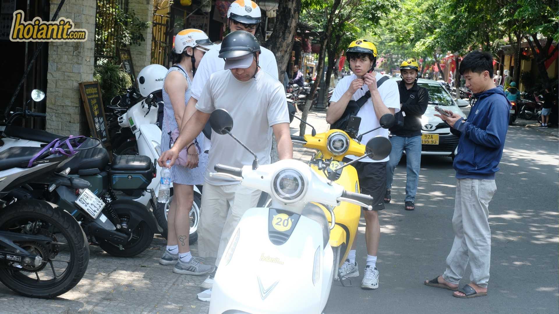 US citizen motorcycle license Vietnam3 Travellers checking helmets and paperwork before renting a motorbike in Hoi An