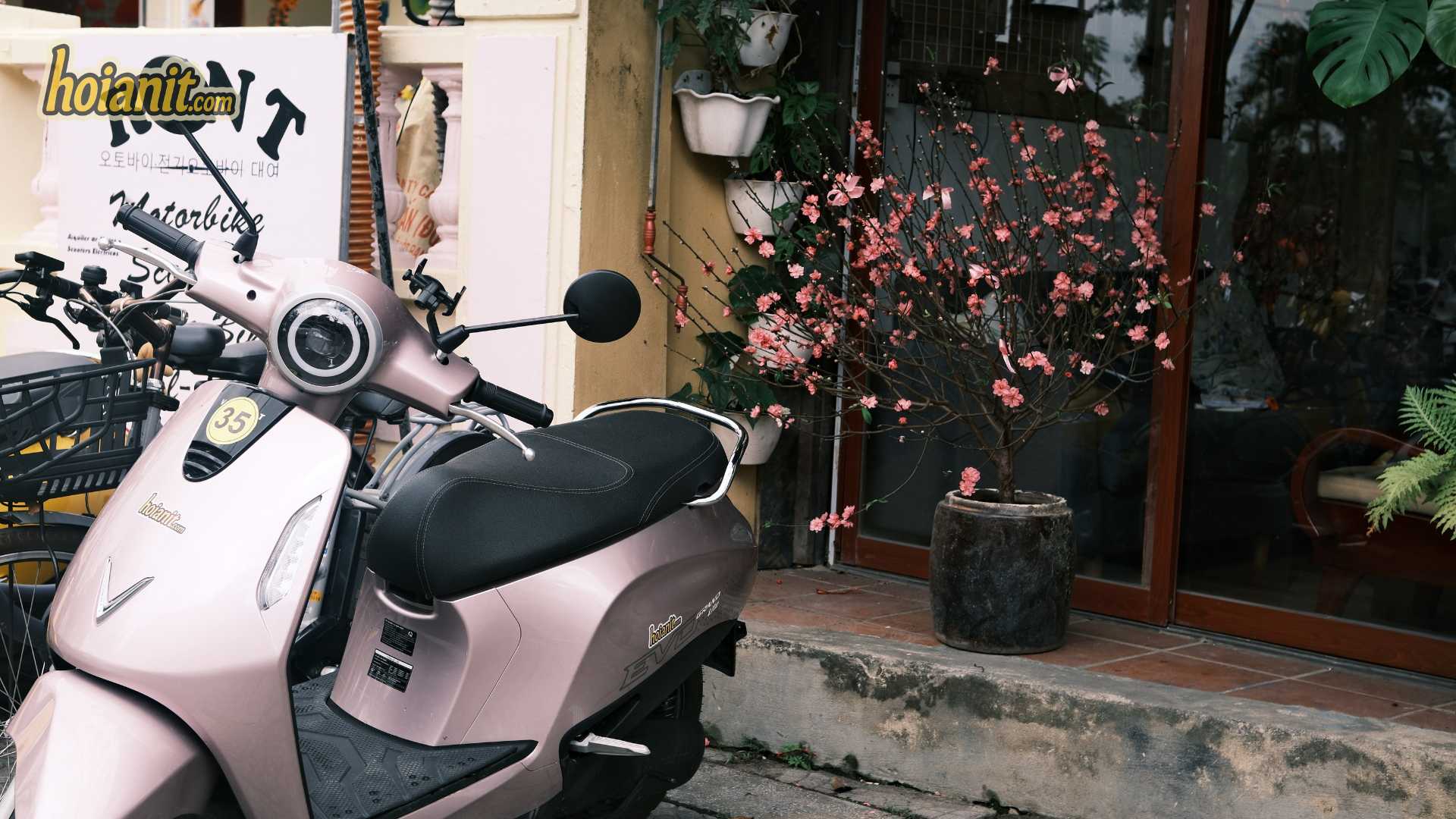 Charging a VinFast scooter from an electric motorbike rental in Hoi An