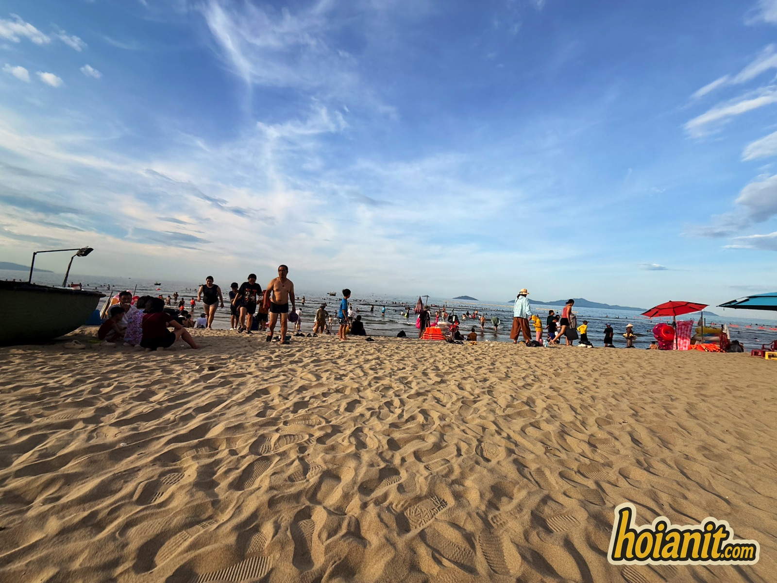 Wide sand at An Bang Beach Hoi An with swimmers at the shoreline
