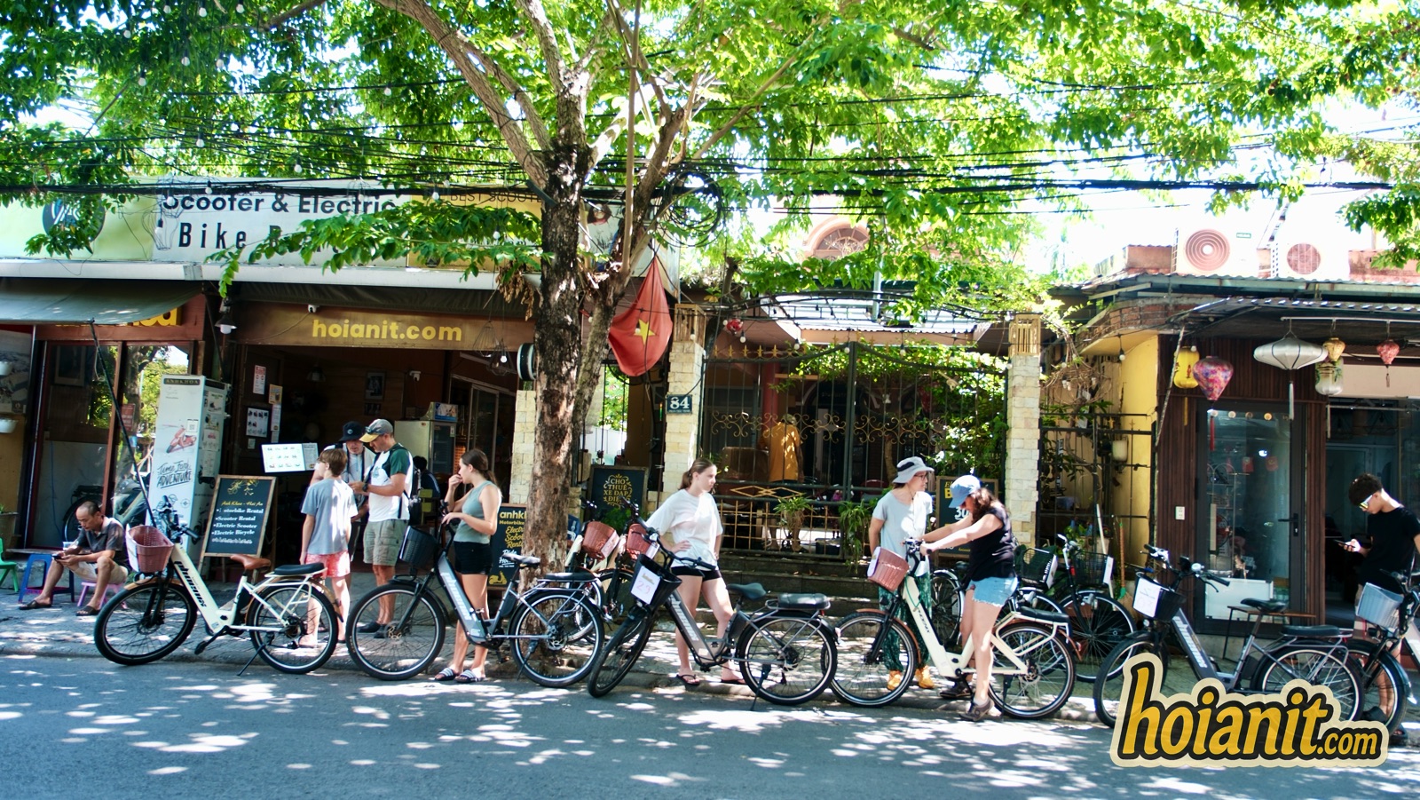 Family with rental bicycles in front of Anh Khoa shop in Hoi An
