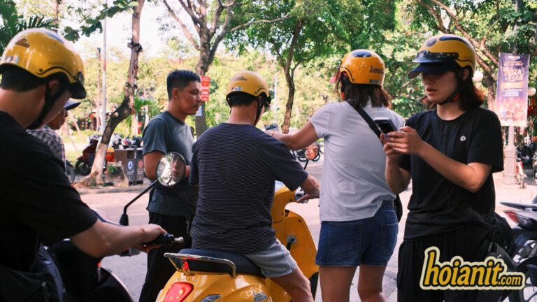 Anh Khoa staff briefing customers before a scooter rental in Hoi An