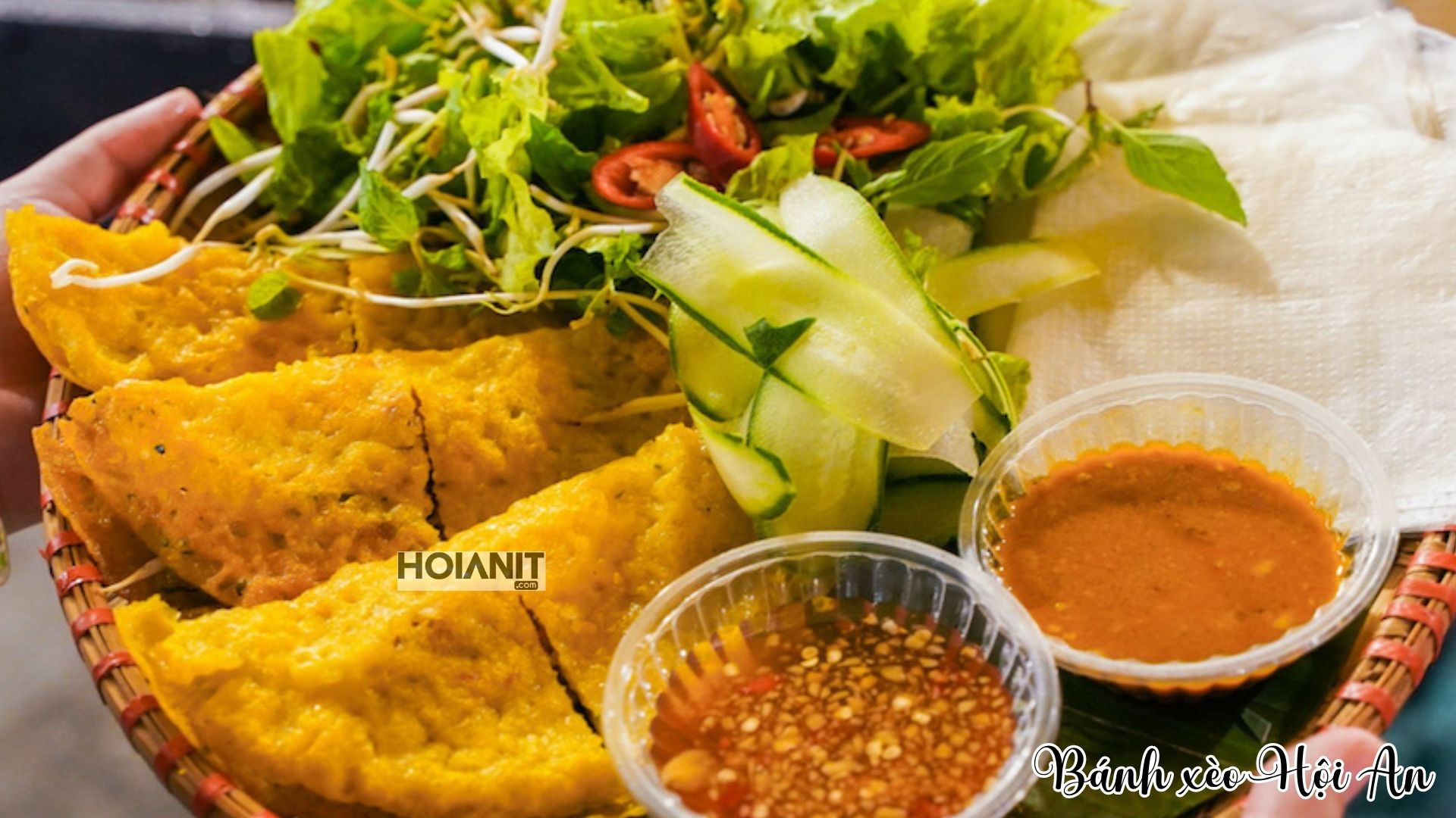 Banh xeo pancakes with herbs, cucumber and dipping sauces in Hoi An