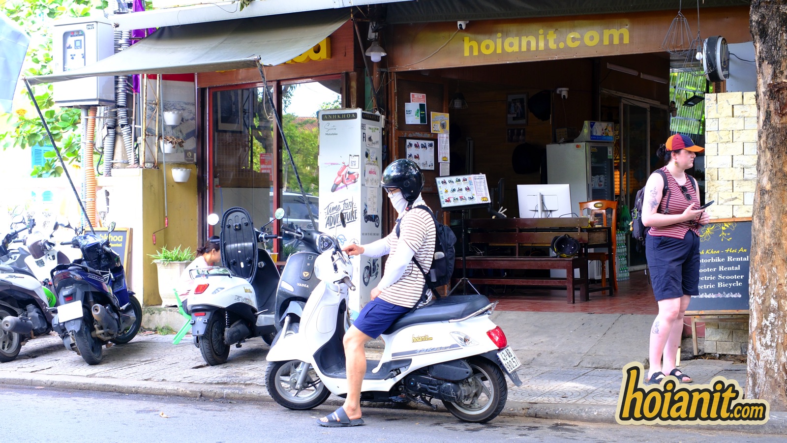 Customer riding an automatic scooter away from Anh Khoa scooter rental in Hoi An at 84 Phan Chau Trinh