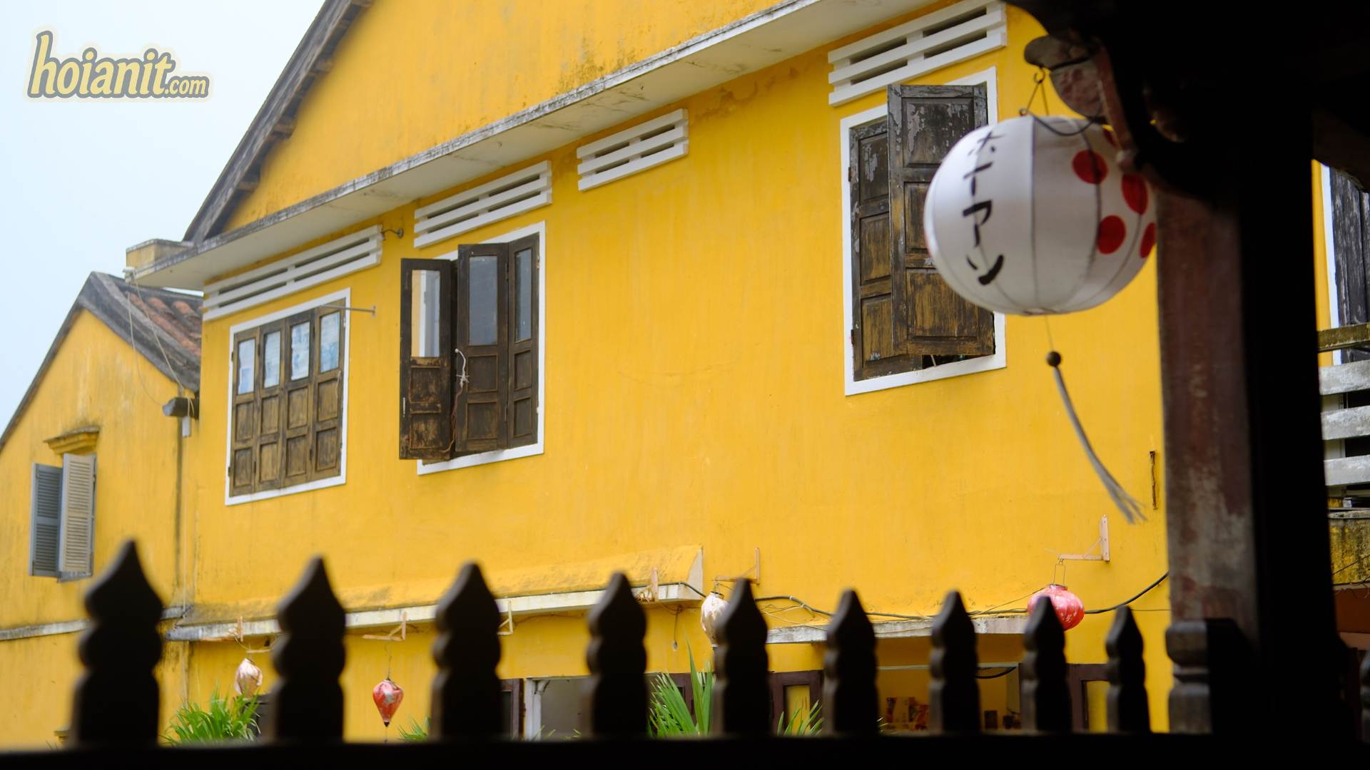 Yellow shophouse with a Japanese lantern in Hoi An Ancient Town