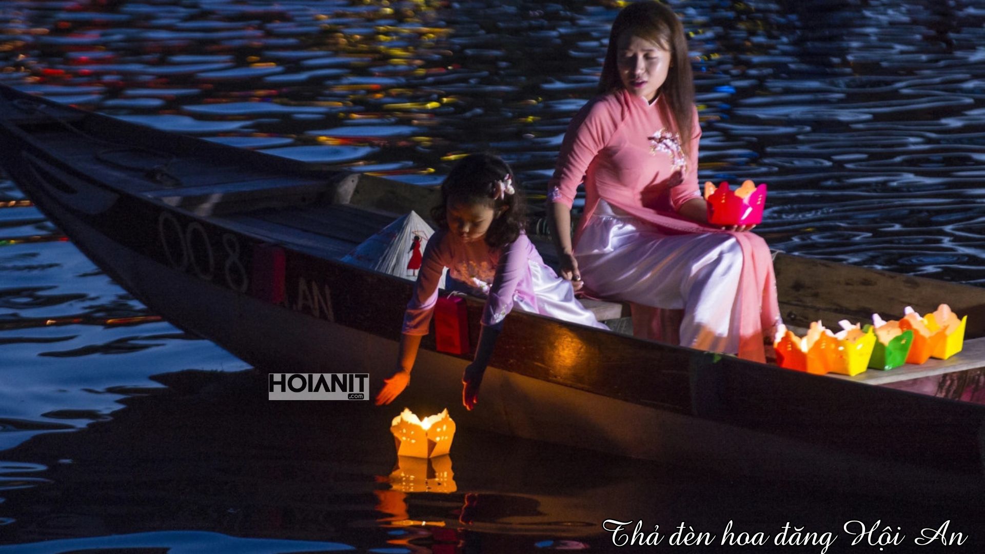 Releasing a paper lantern from a boat on the Hoai River before visiting the best bars in Hoi An