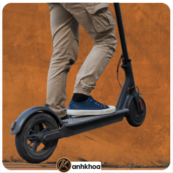 Close-up of legs standing on a black electric scooter – eco-friendly transport by Anh Khoa