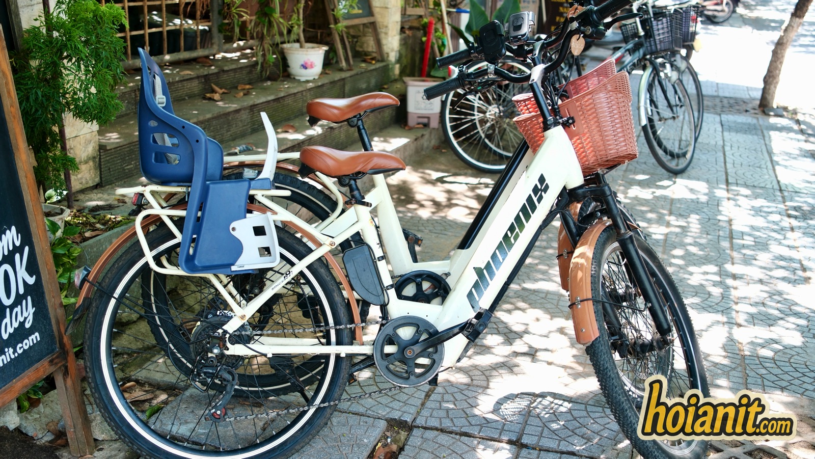 electric bicycle child seat basket hoi an rental Electric bicycle with a blue rear child seat and front basket for family rental in Hoi An