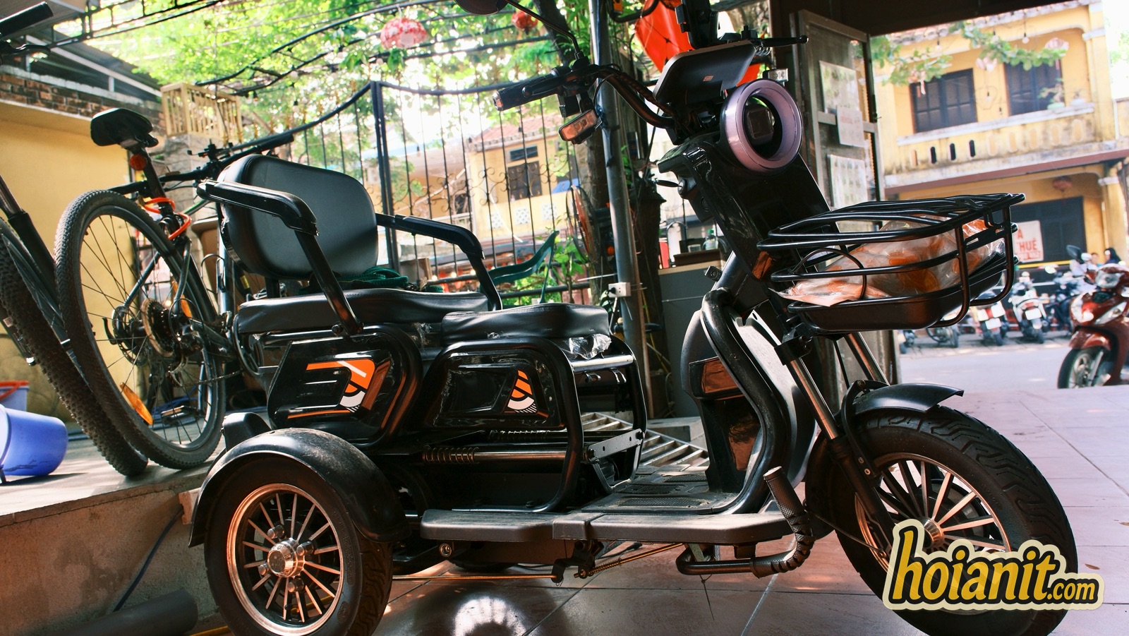 electric tricycle three wheel ebike hoi an rental Electric tricycle with a rear seat and backrest parked outside the rental shop in Hoi An