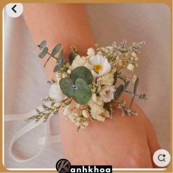 Hand-tied flower wrist corsage featuring yellow roses, white roses, and baby's breath from Hoi An