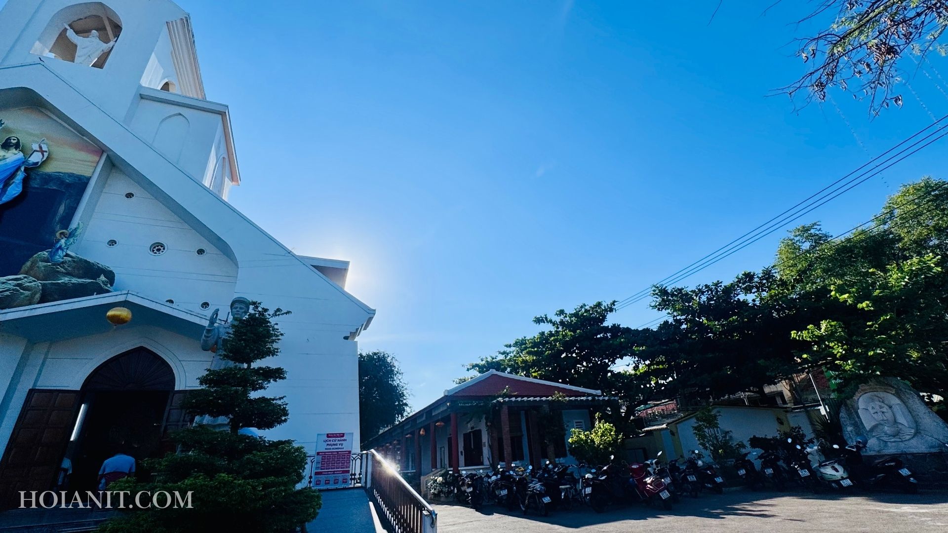 hoi an catholic church3 Hoi An Catholic church exterior with palm trees and blue sky in the background