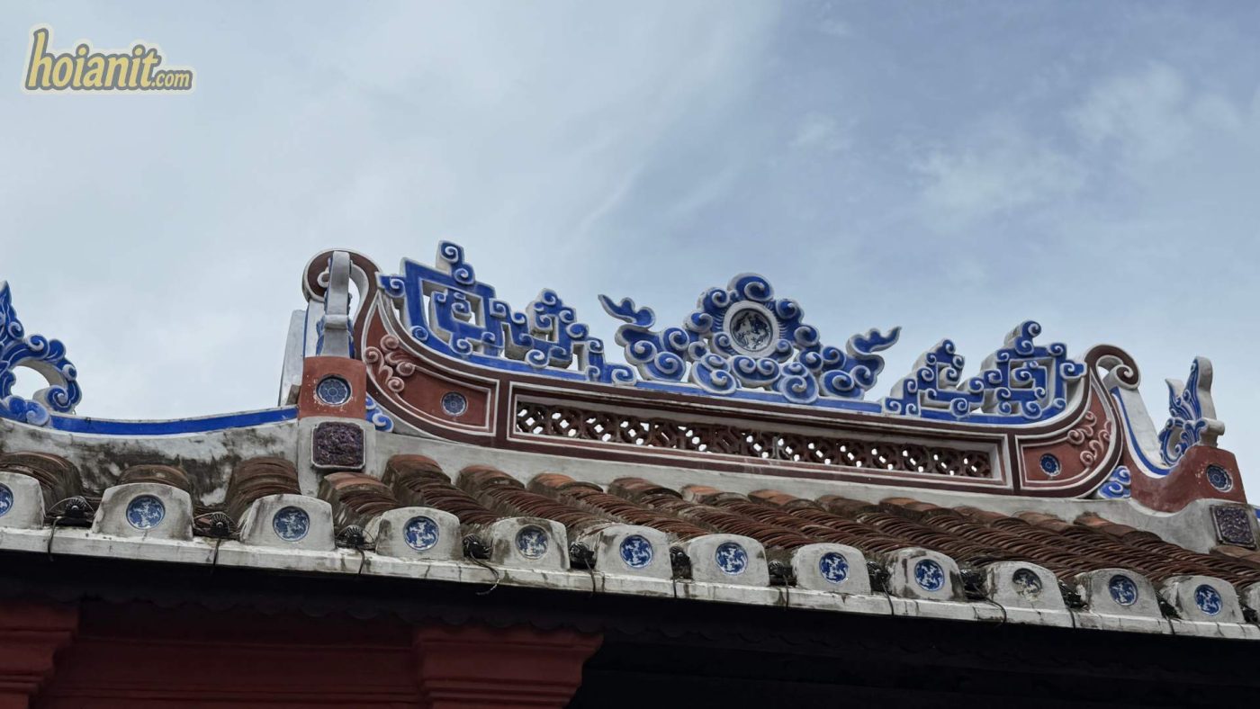 Tourists walking across the Japanese Bridge in Hoi An