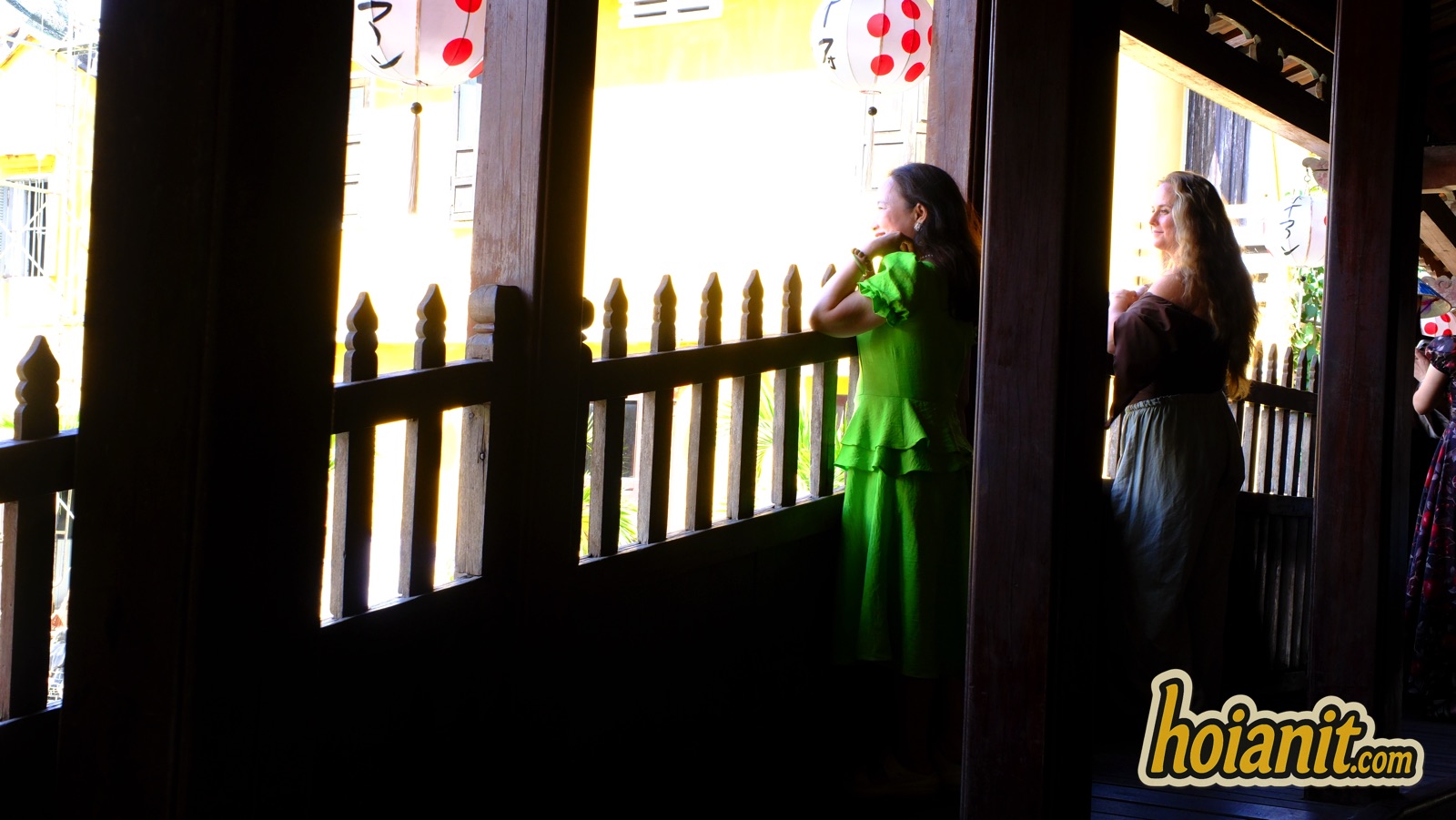 japanese covered bridge11 Two visitors in ao dai photographed through the wooden railing of the Japanese Covered Bridge