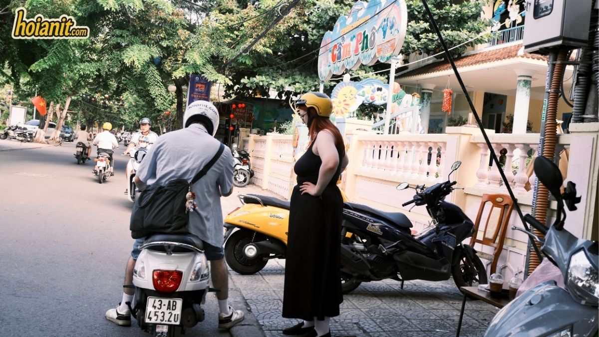 Travellers with helmets picking up their rental motorbikes in Hoi An