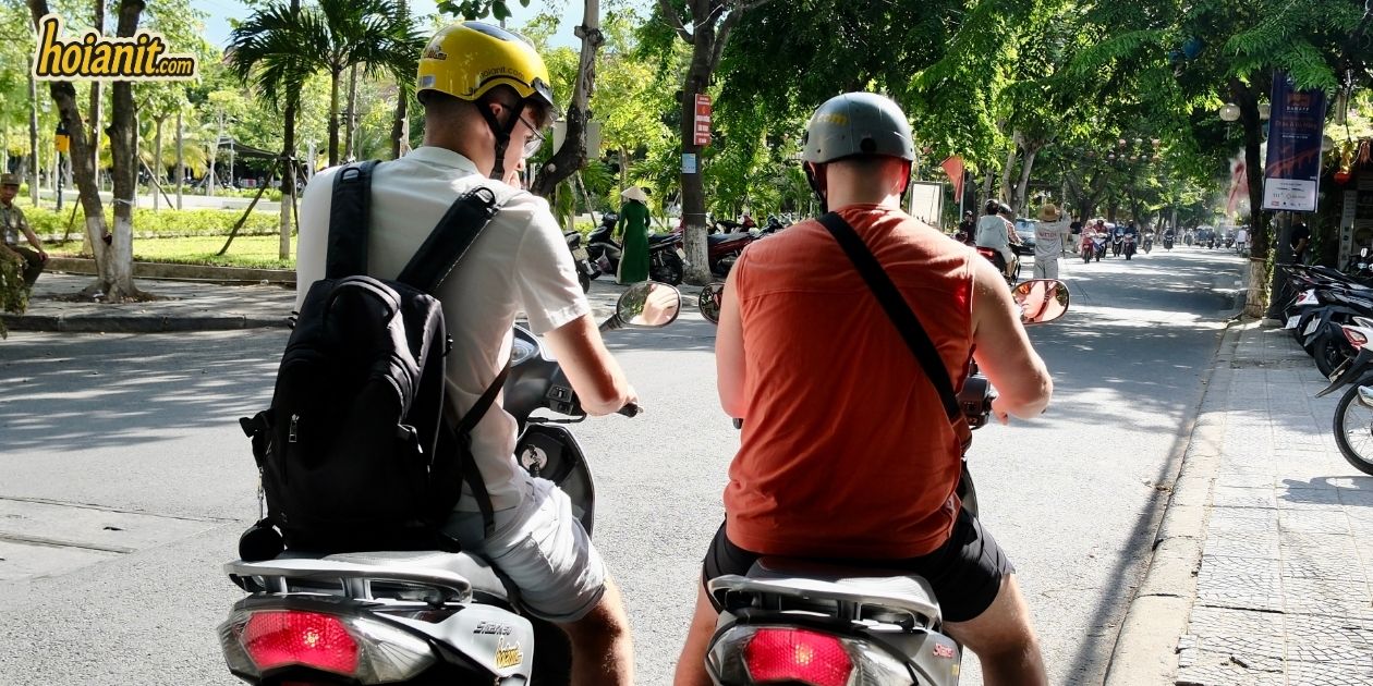 Two riders on the coastal road from Hoi An heading to the Dragon Bridge in Da Nang