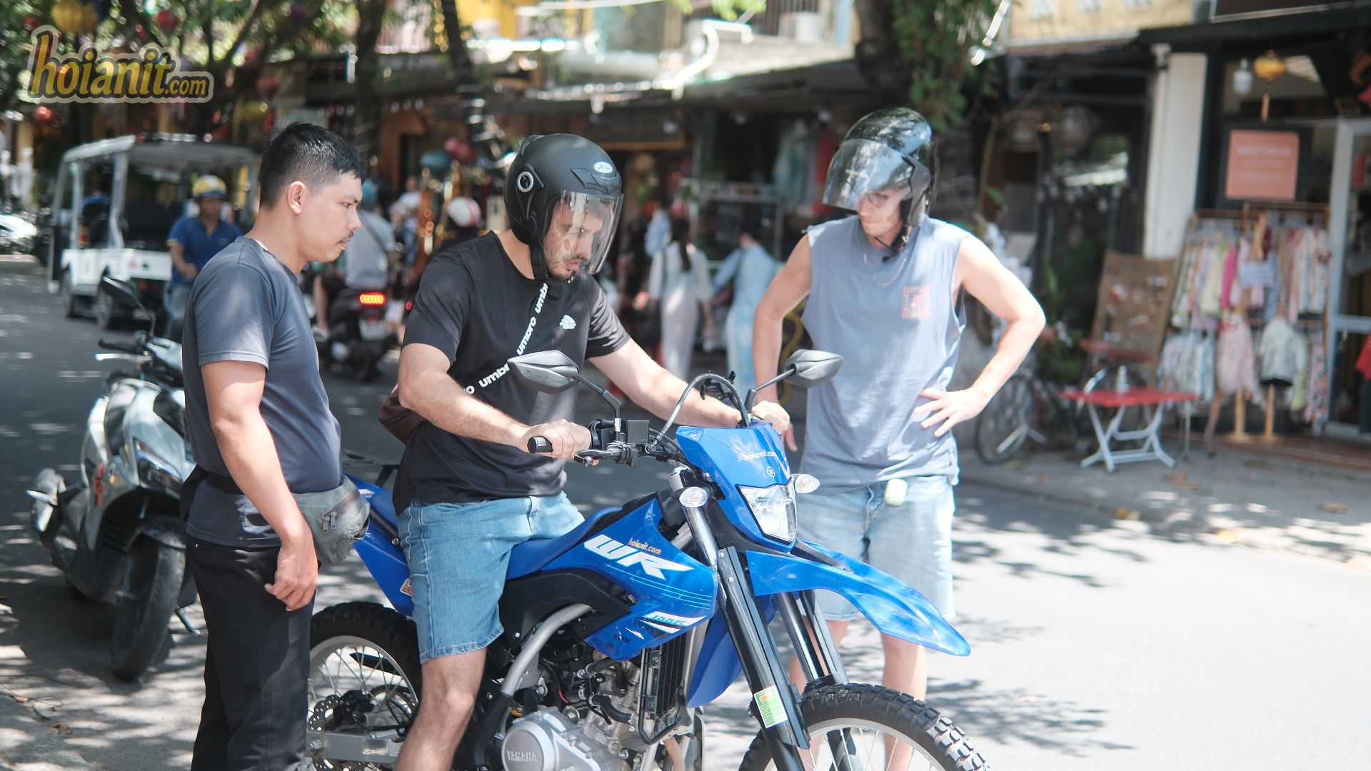 Motorbike handover on a Hoi An street before a ride to the beach festivals near Hoi An