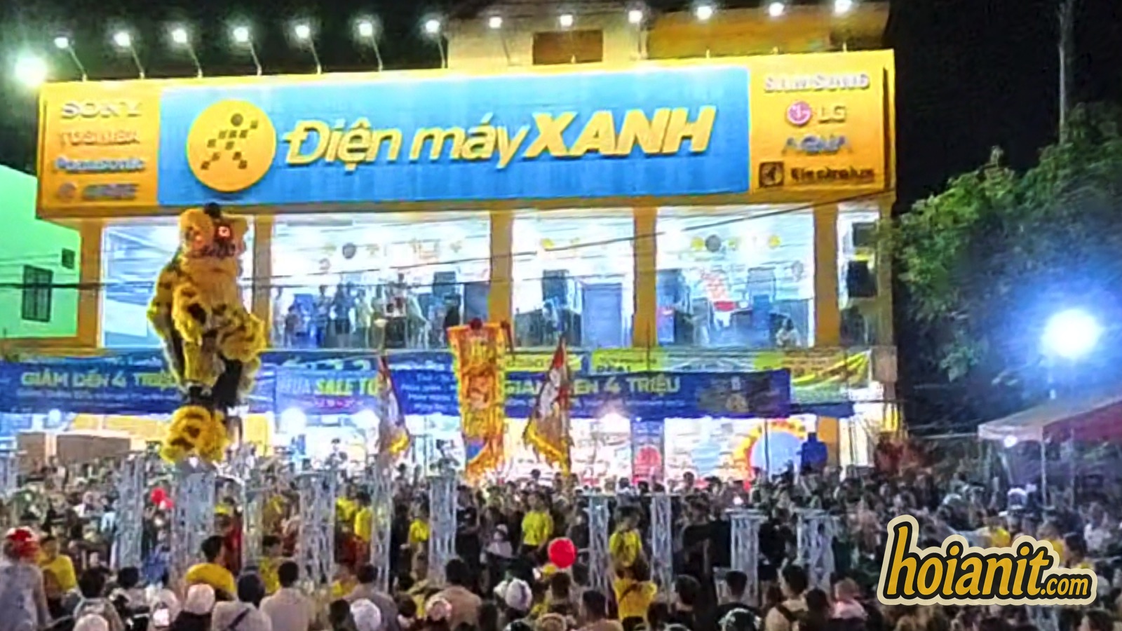 Crowd watching a Mid-Autumn Festival lion dance in Hoi An, lion on a pole at the left