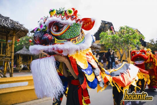 Thien Cau dance in Hoi An, five-coloured head with white beard, a red lion behind