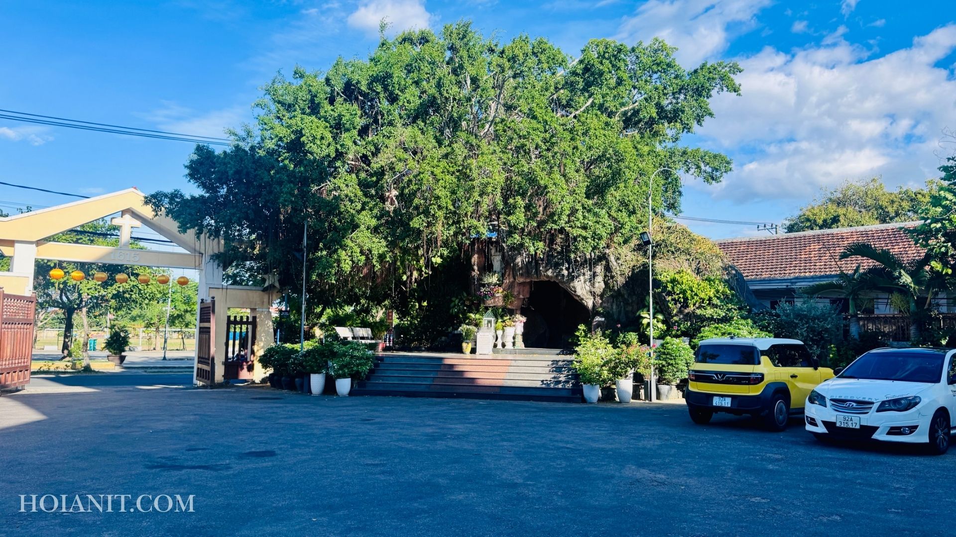 Ngoại cảnh nhà thờ Công giáo Hội An với hàng dừa và nền trời xanh