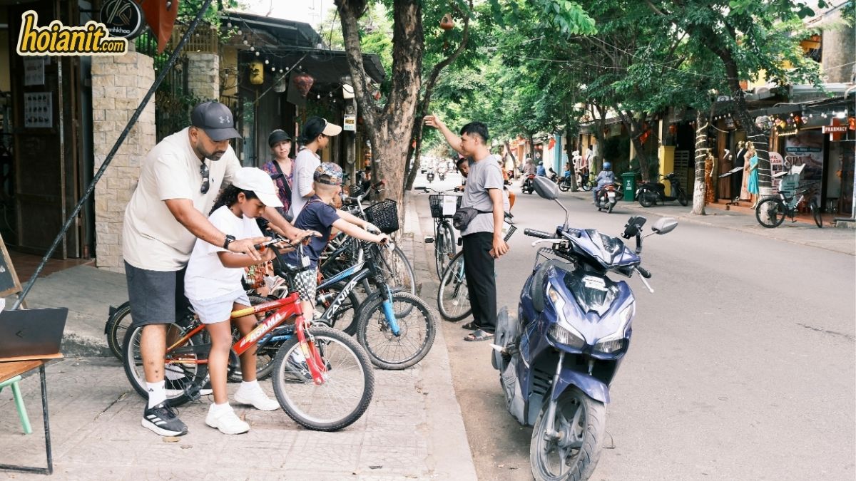 Rider being shown how to handle a bike safely on a quiet street